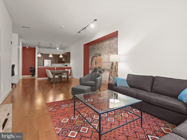 living room featuring wood-type flooring and track lighting