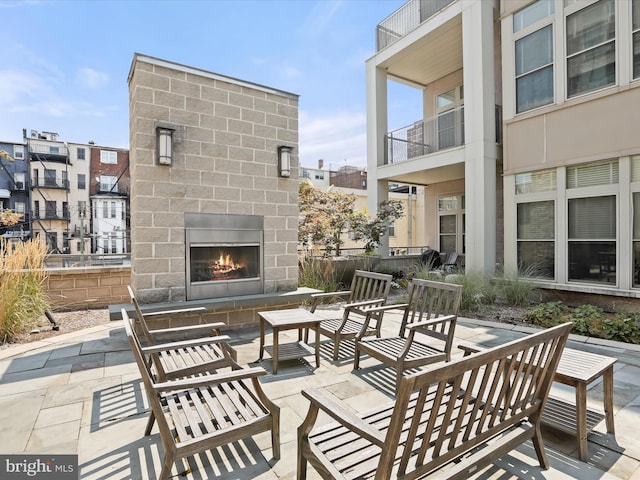 view of patio featuring an outdoor living space with a fireplace