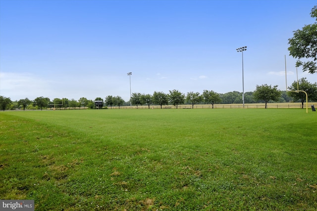 view of property's community with a rural view and a yard