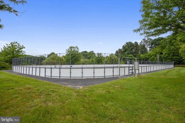 view of pool with a lawn