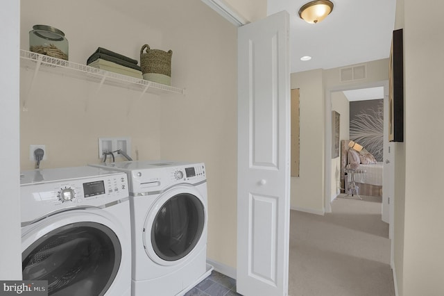 clothes washing area with washing machine and clothes dryer and carpet