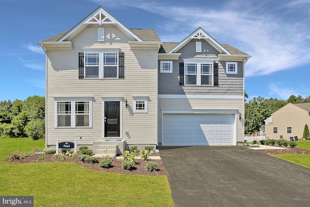 view of front of house with a garage and a front lawn