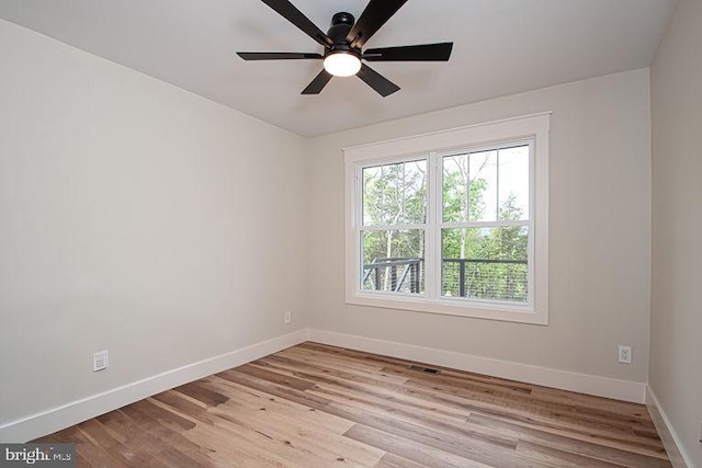 empty room with light hardwood / wood-style floors and ceiling fan