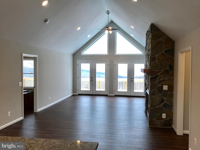 unfurnished living room with lofted ceiling, ceiling fan, french doors, and dark hardwood / wood-style floors