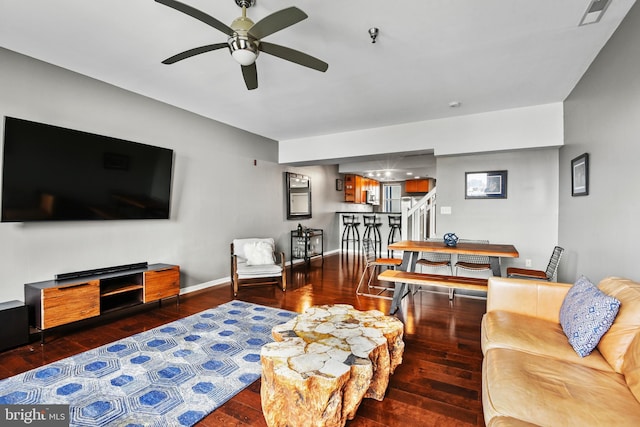 living room featuring ceiling fan and wood-type flooring