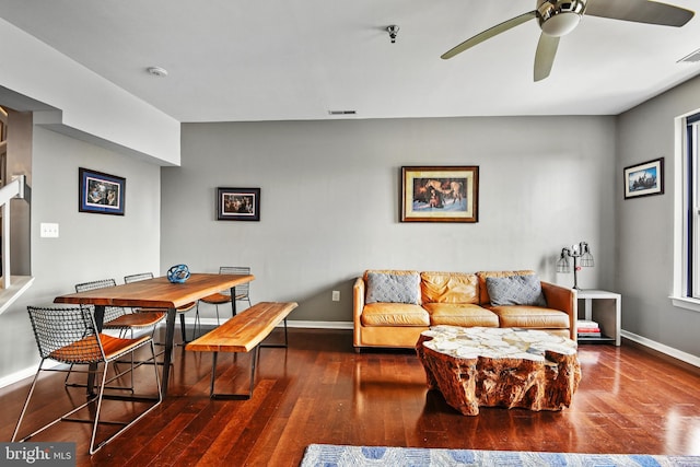 living room with ceiling fan and dark hardwood / wood-style flooring