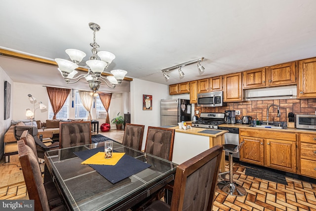 dining space with a chandelier and sink