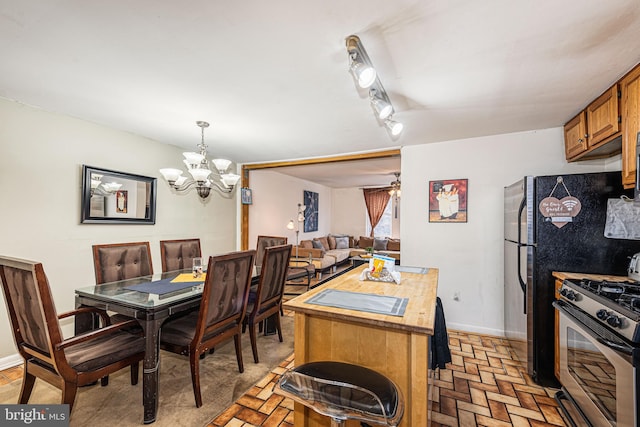 dining space featuring ceiling fan with notable chandelier