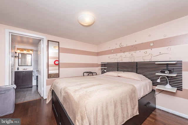 bedroom with connected bathroom and dark tile patterned flooring