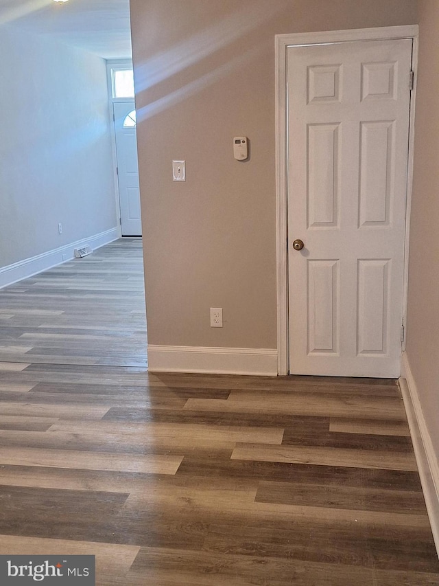 spare room featuring dark hardwood / wood-style flooring