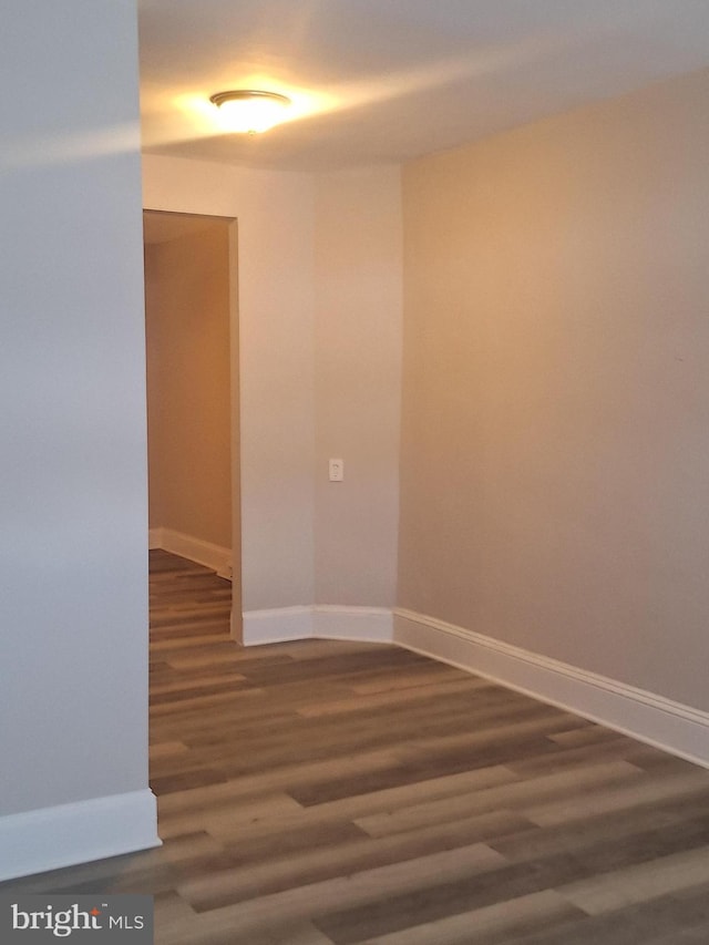 empty room with dark wood-type flooring