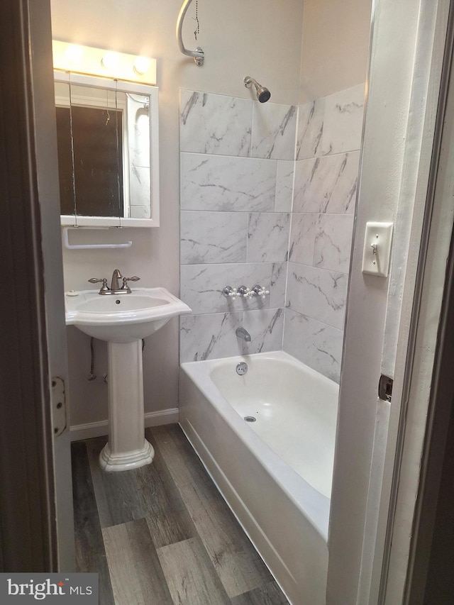 bathroom featuring sink, tiled shower / bath combo, and hardwood / wood-style flooring