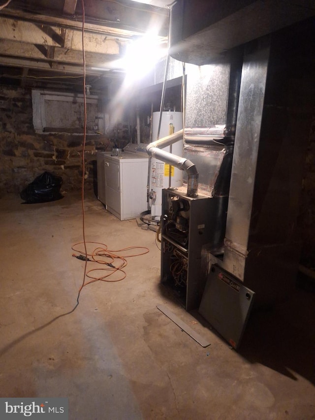 basement with washing machine and clothes dryer and gas water heater