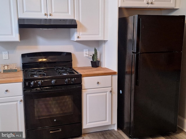 kitchen with white cabinets, butcher block countertops, and black appliances