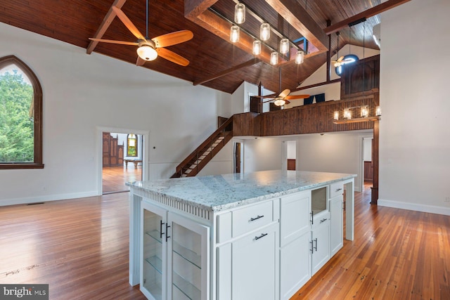 kitchen featuring white cabinets, ceiling fan, wood ceiling, and high vaulted ceiling