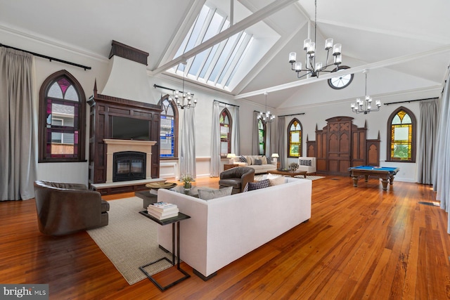 living room featuring hardwood / wood-style floors, a wealth of natural light, high vaulted ceiling, and pool table