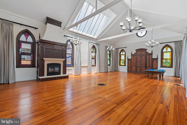 unfurnished living room featuring hardwood / wood-style flooring, high vaulted ceiling, and billiards