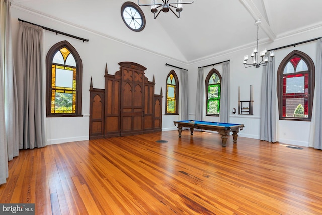 playroom with ornamental molding, a notable chandelier, light wood-type flooring, vaulted ceiling, and pool table