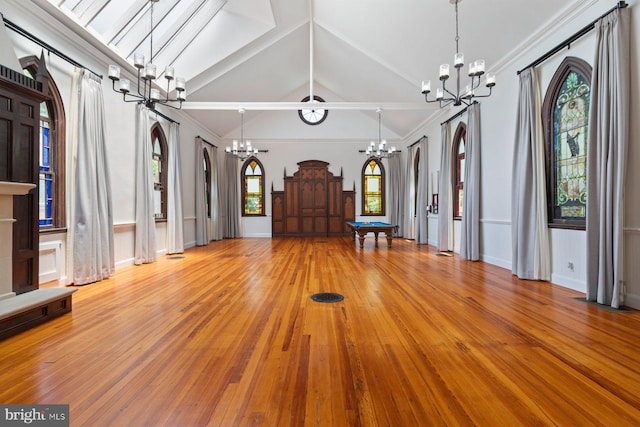 entrance foyer with hardwood / wood-style flooring, ornamental molding, pool table, and vaulted ceiling