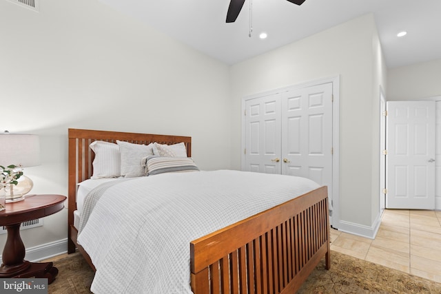 tiled bedroom featuring a closet and ceiling fan