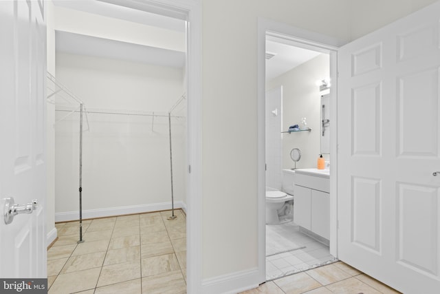 bathroom with tile patterned floors, vanity, and toilet