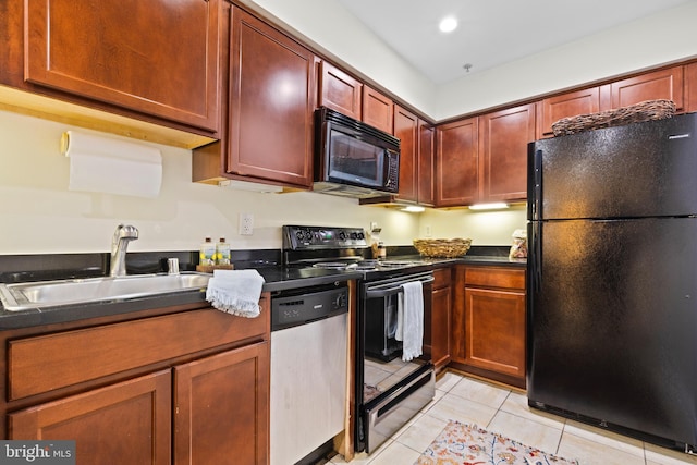 kitchen with sink, light tile patterned floors, and black appliances