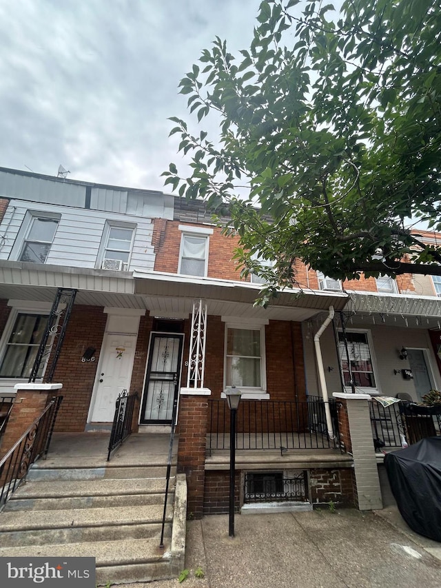 townhome / multi-family property with covered porch