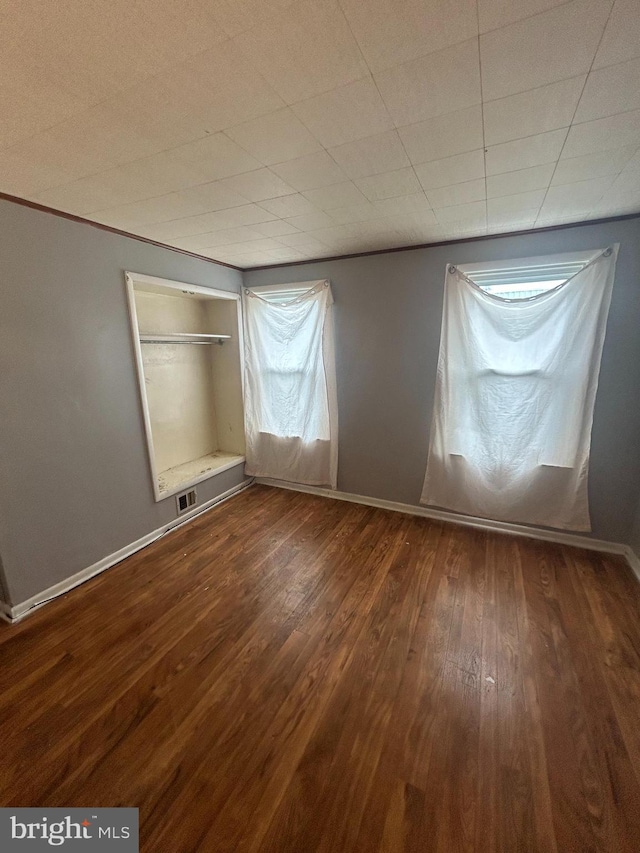 spare room with dark hardwood / wood-style flooring