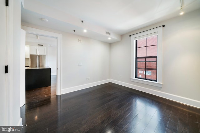 unfurnished room featuring dark hardwood / wood-style flooring