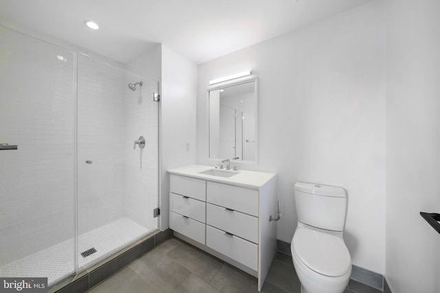 bathroom featuring an enclosed shower, vanity, and toilet