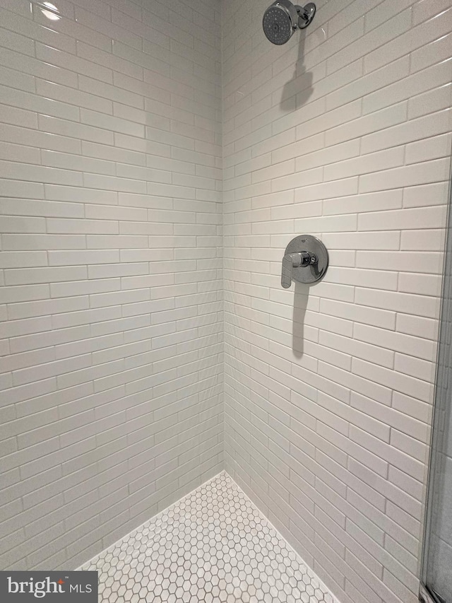 bathroom with tiled shower