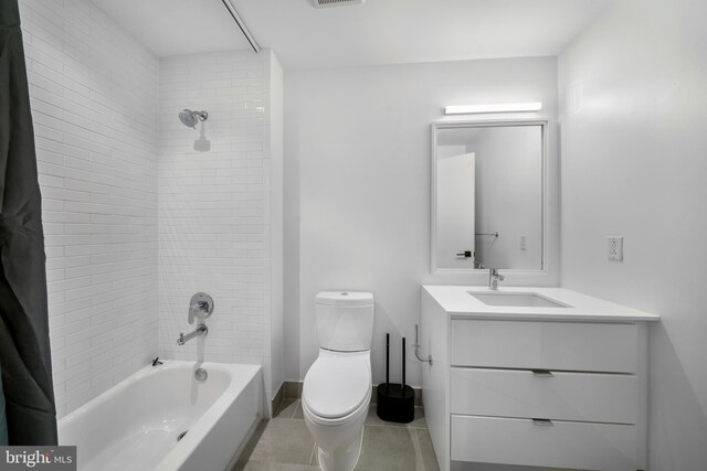 full bathroom with tile patterned floors, toilet, vanity, and tiled shower / bath