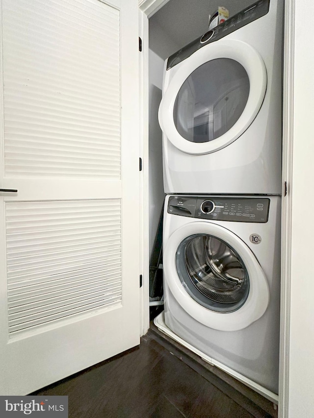 washroom with stacked washer / drying machine