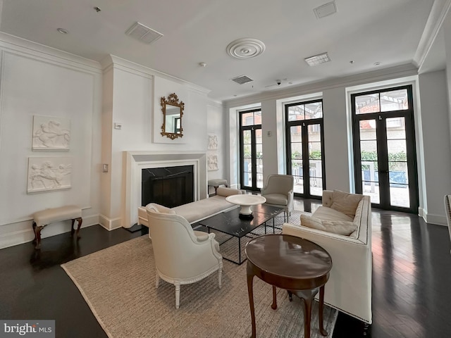 interior space with dark hardwood / wood-style flooring, crown molding, and french doors