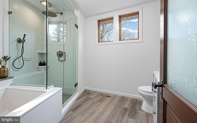 75 Church St, Beverly, NJ 08010 - bathroom featuring a shower with shower door, hardwood / wood-style flooring, and toilet