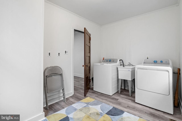 75 Church St, Beverly, NJ 08010 - clothes washing area featuring washer and dryer, light hardwood / wood-style floors, and ornamental molding