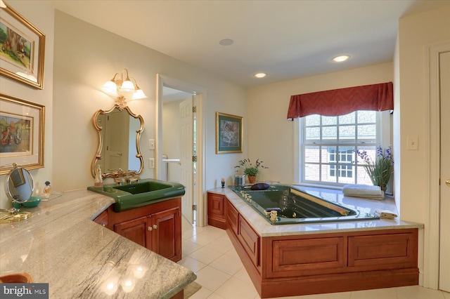 bathroom featuring a bathtub, tile patterned flooring, and vanity