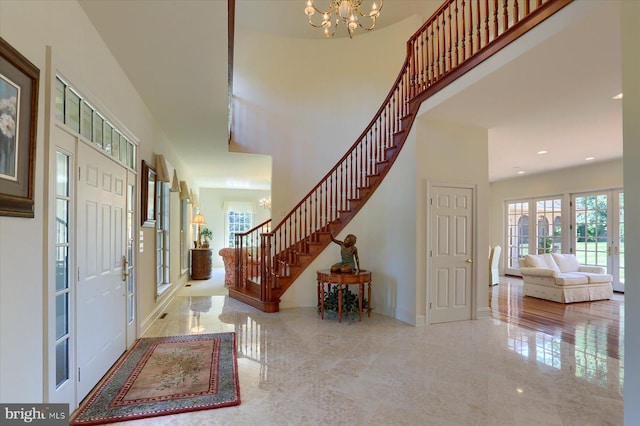 entryway featuring a high ceiling and a notable chandelier