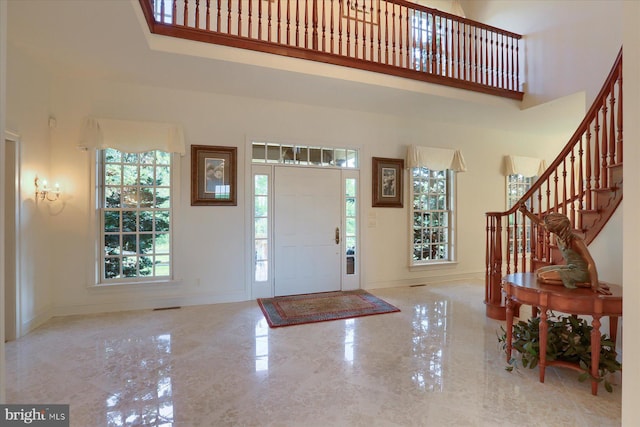 entryway featuring a towering ceiling