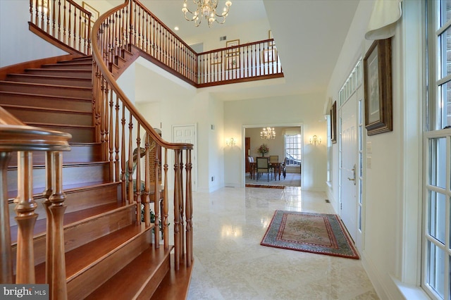 foyer with a notable chandelier and a towering ceiling