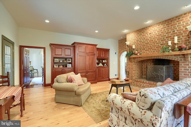 living room with a fireplace and light hardwood / wood-style flooring