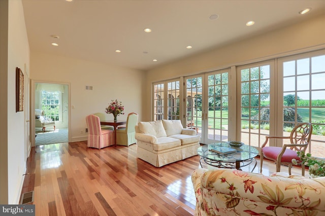 living room with light wood-type flooring and french doors