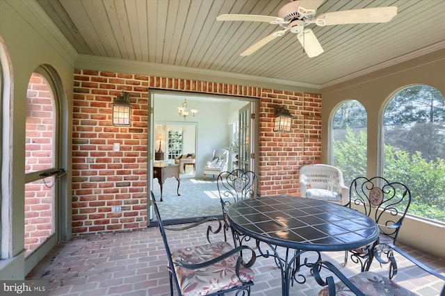 sunroom with ceiling fan with notable chandelier