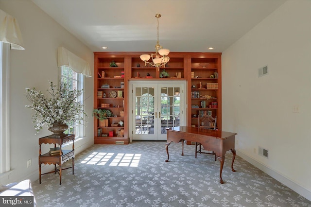 home office featuring carpet, french doors, built in features, and a notable chandelier