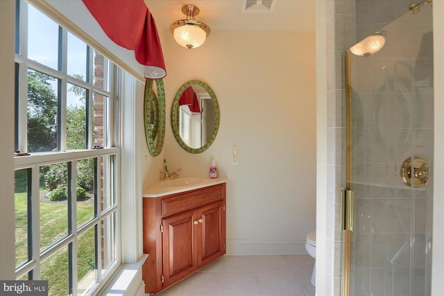 bathroom featuring tile patterned floors, vanity, an enclosed shower, and toilet