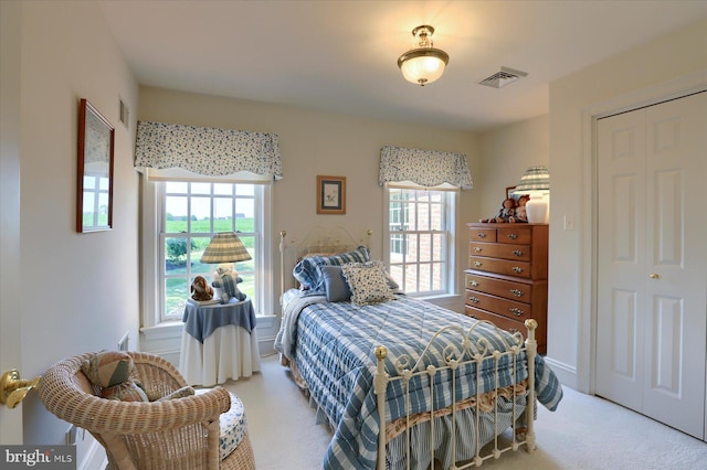 carpeted bedroom with a closet