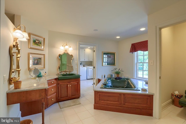 bathroom with washer and dryer, vanity, and tile patterned flooring