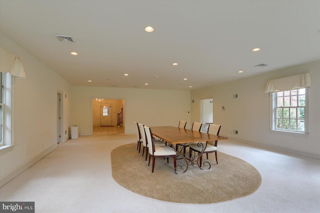 dining space featuring light colored carpet