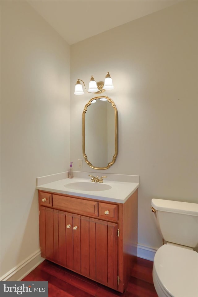 bathroom featuring hardwood / wood-style flooring, vanity, and toilet