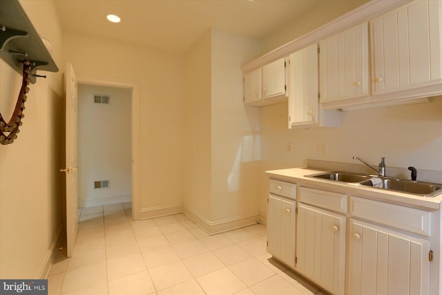 kitchen with white cabinetry and sink